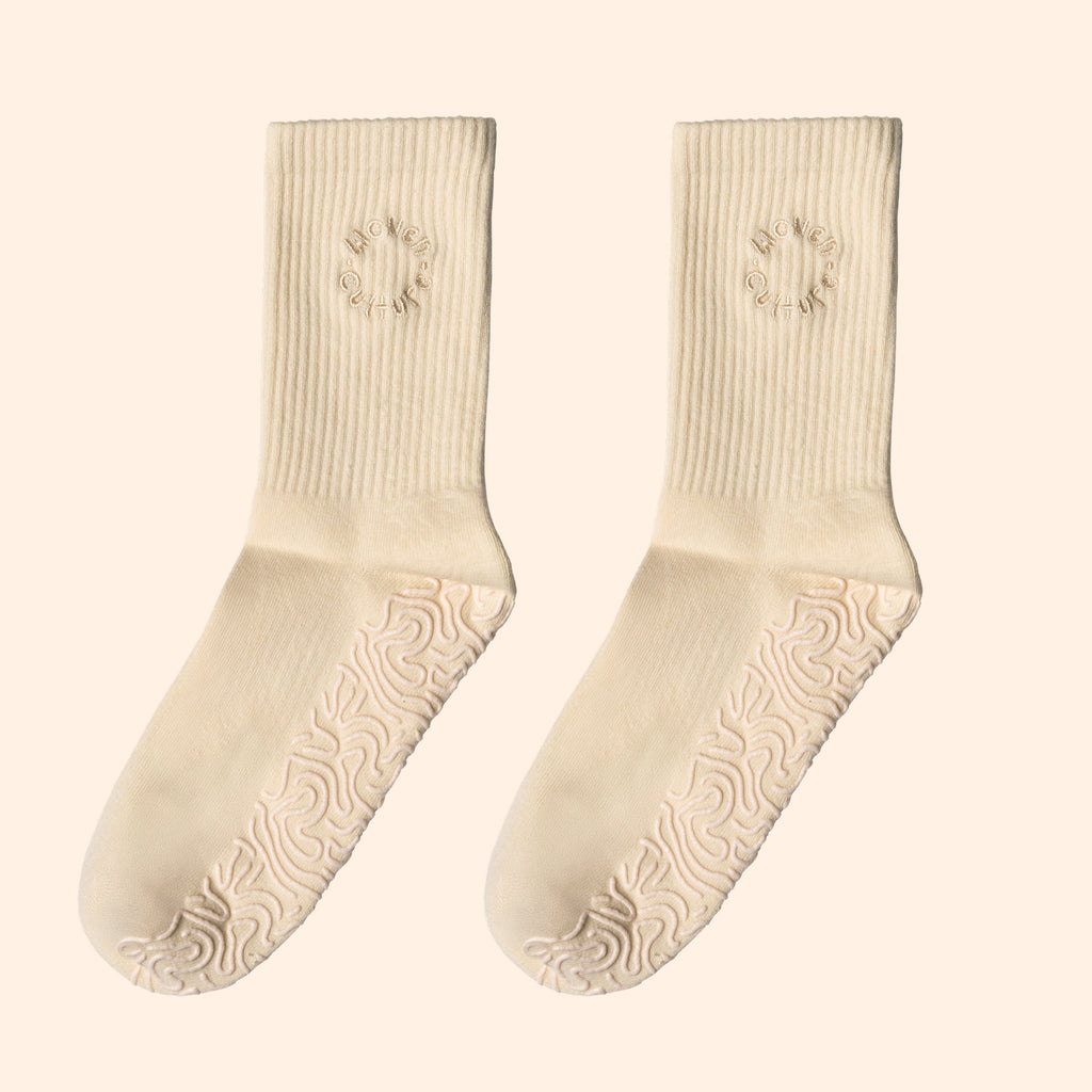 Cream organic cotton grip socks with non-slip sole and Woven Culture logo, sustainable yoga and Pilates socks.